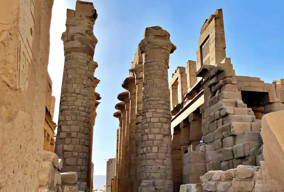 A breathtaking sunrise over the ancient Karnak Temple in Luxor, Egypt, with golden light illuminating massive stone columns and hieroglyphs, tourists exploring the site, the Nile River in the distance, realistic photography style, high detail, travel magazine quality.